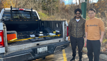 Two men standing next to a pickup truck