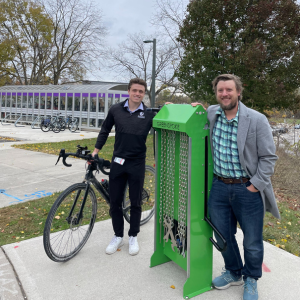 Two people standing next to a bike repair station