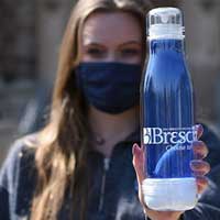 Person holding up a water reusable water bottle