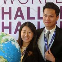 Pair in front of a World Challenge Challenge banner