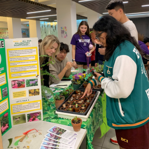 People standing around a booth